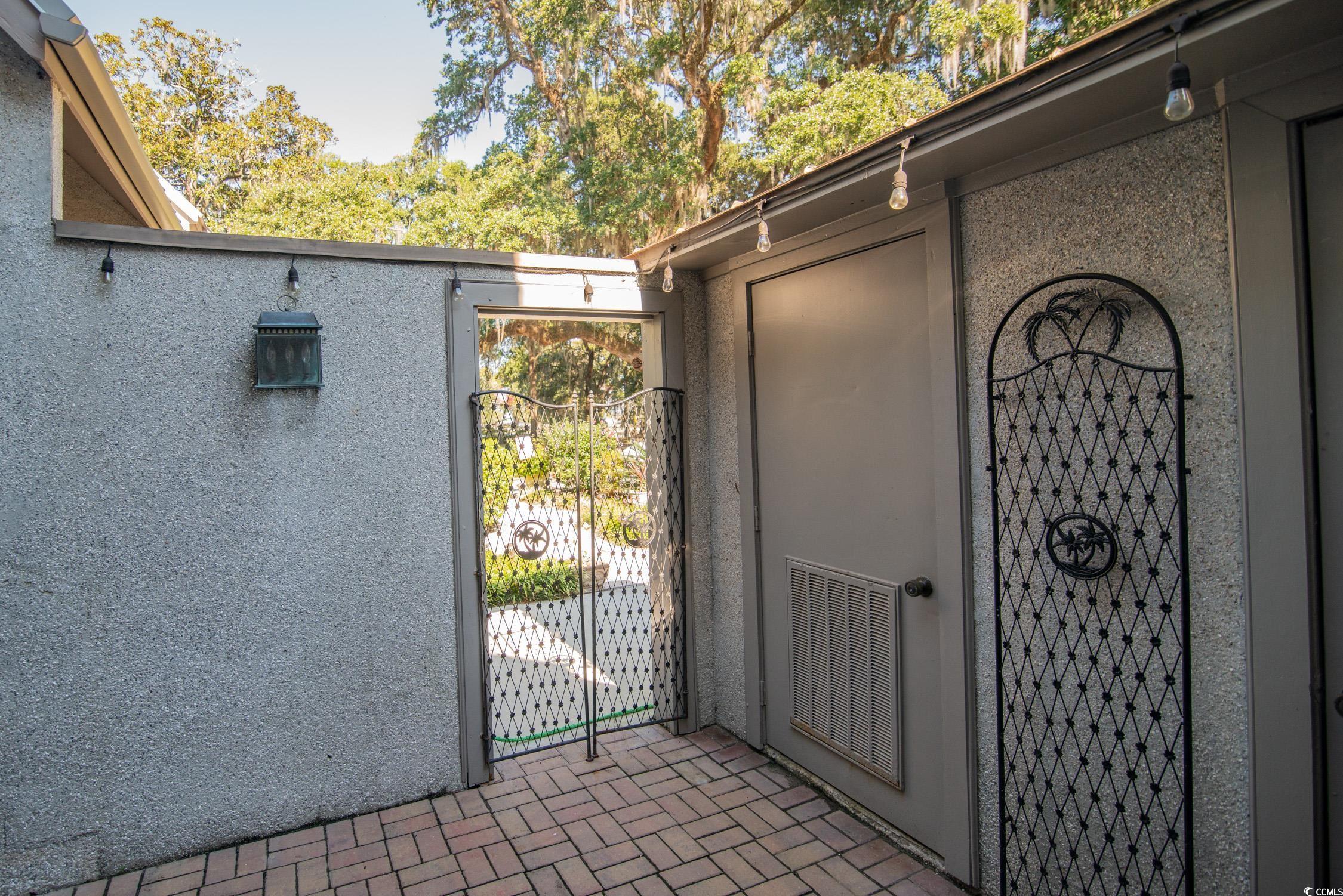 63 Battery White Court, Unit 2C Georgetown, SC 29440 - Photo 12 of 38 Entrance to property with a gate and stucco siding