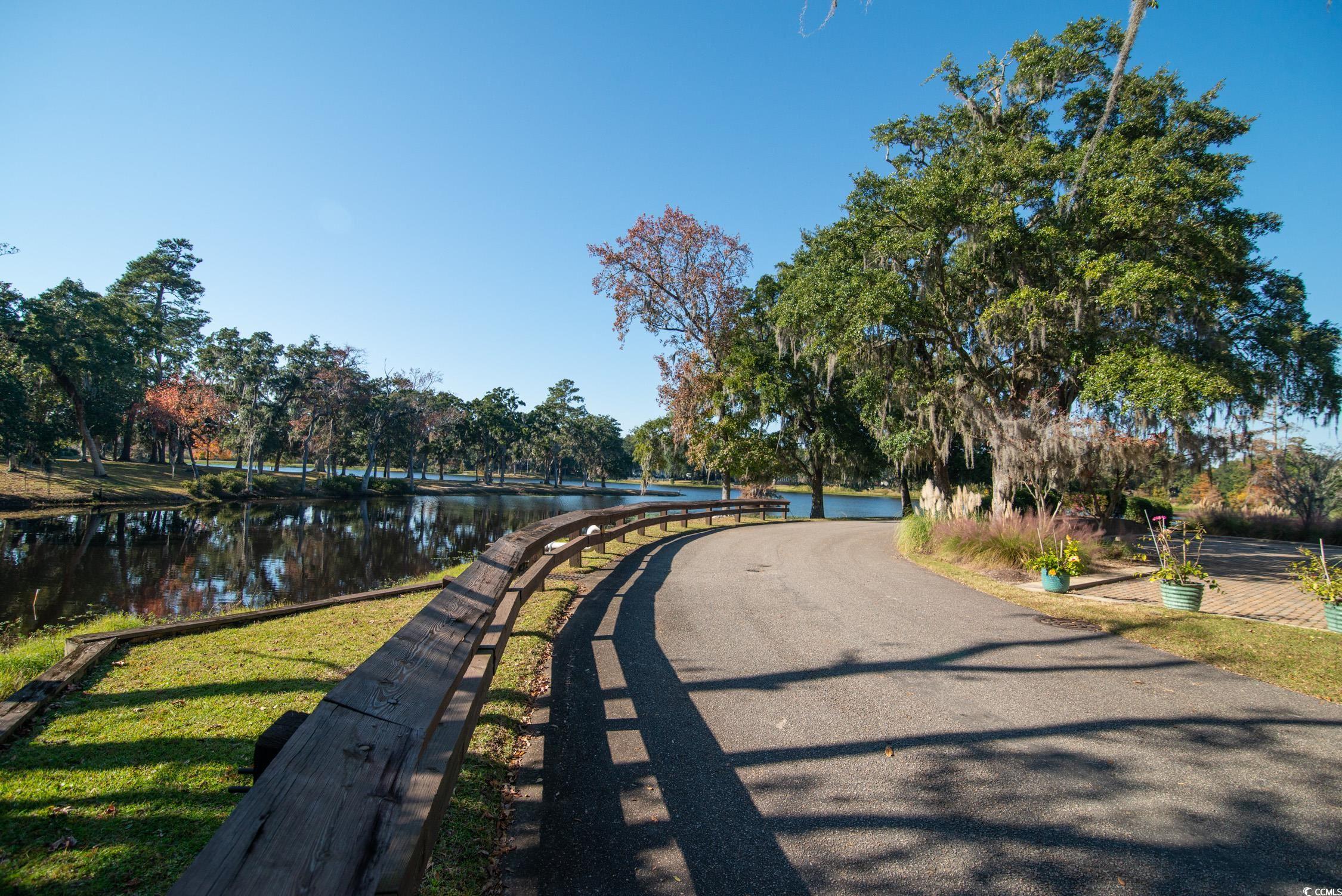 63 Battery White Court, Unit 2C Georgetown, SC 29440 - Photo 36 of 38 View of property's community featuring a water view and a lawn