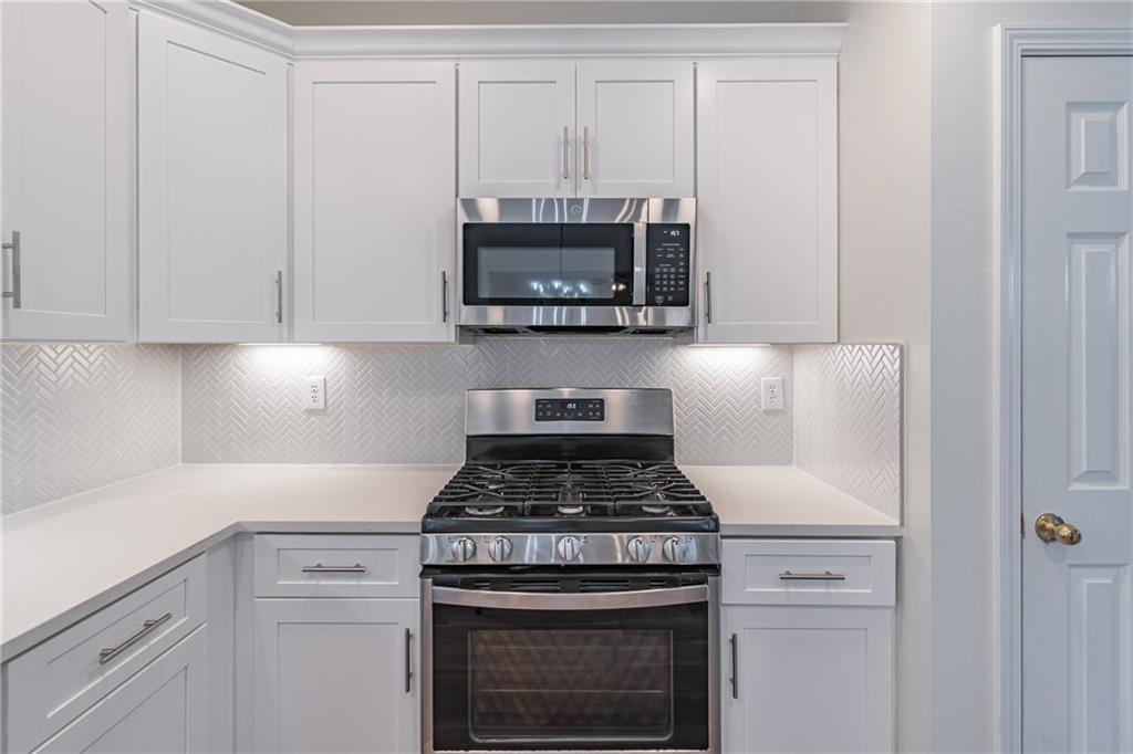 1324 Crescentwood Lane Decatur, GA 30032 - Photo 21 of 58 a kitchen with a stove and white cabinets