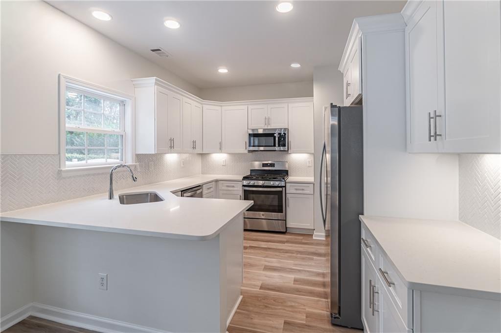 1324 Crescentwood Lane Decatur, GA 30032 - Photo 23 of 58 a kitchen with kitchen island a sink stove and refrigerator