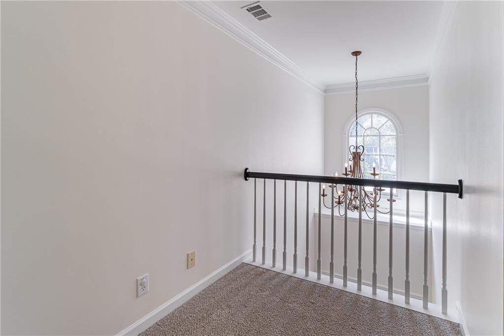 1324 Crescentwood Lane Decatur, GA 30032 - Photo 49 of 58 a view of a hallway with a chandelier fan