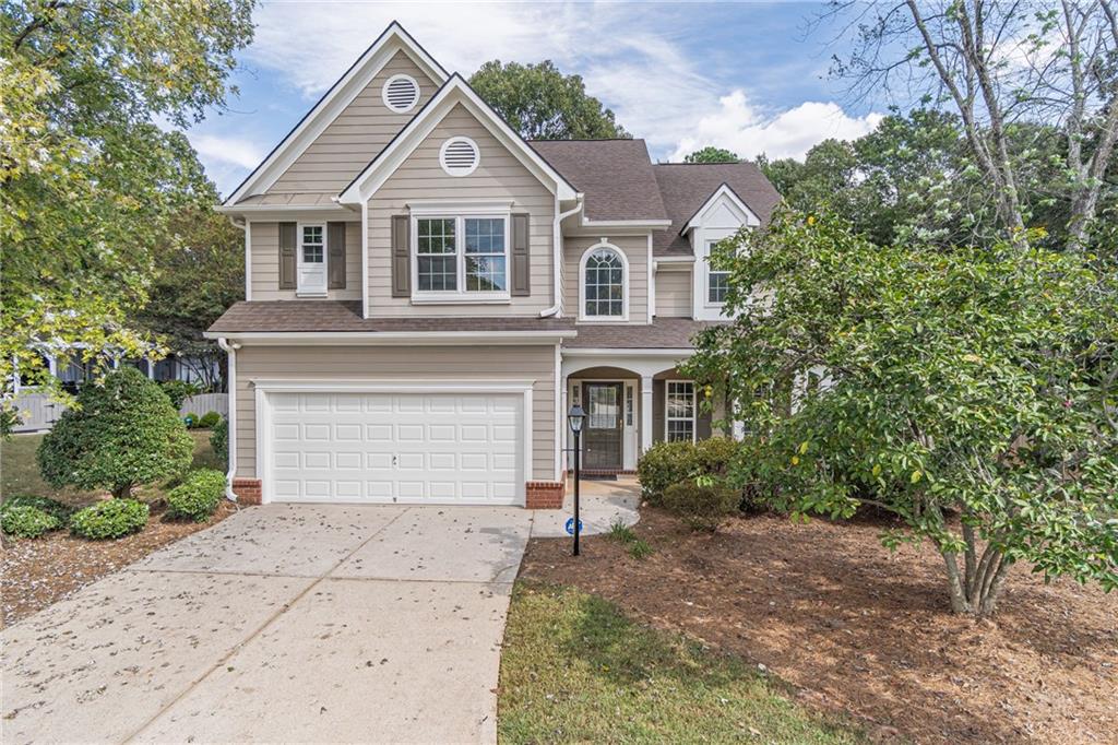 1324 Crescentwood Lane Decatur, GA 30032 - Photo 52 of 58 a front view of a house with a yard and garage