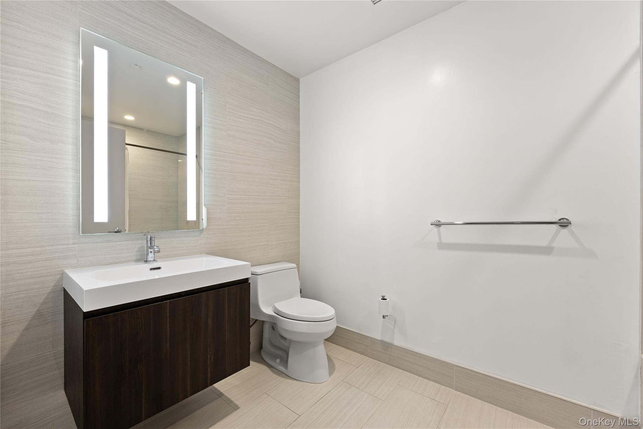 131-01 40 Road, Unit PH3F Queens, NY 11354 - Photo 15 of 30 a bathroom with a sink and a mirror