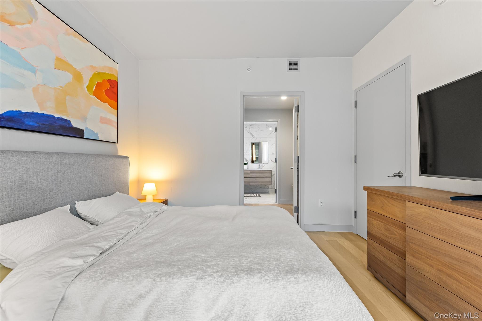 131-01 40 Road, Unit PH3F Queens, NY 11354 - Photo 19 of 30 a bedroom with a bed and a flat screen tv