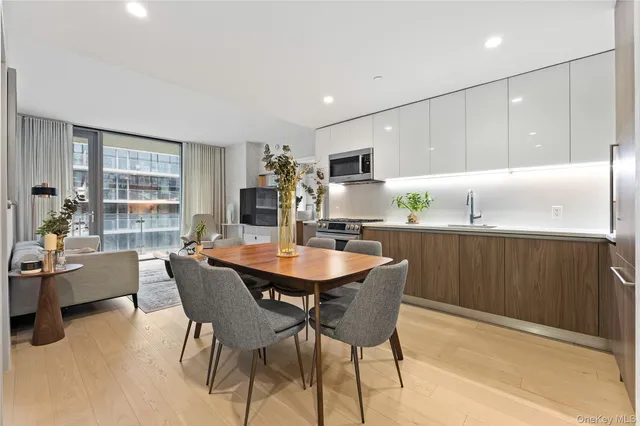 a kitchen with a table chairs refrigerator and cabinets