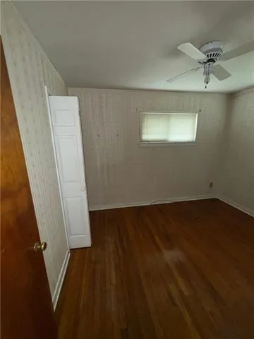 wooden floor in an empty room with a mirror