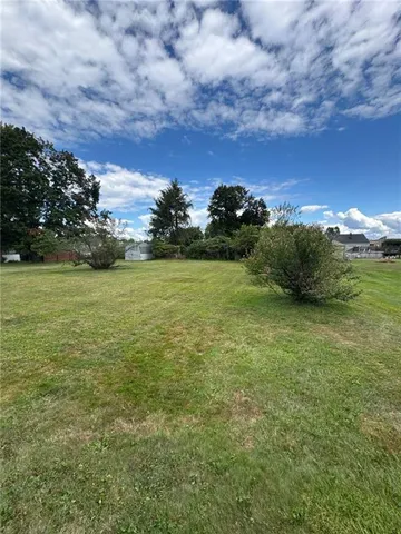 a view of a field with an ocean