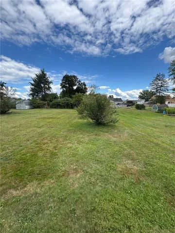 a view of a field with an ocean