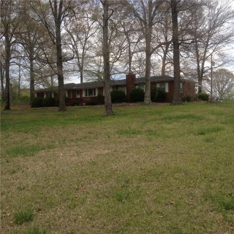 1245 Breeden Road Charlotte, TN 37036 - Photo 1 of 13 BACK ON THE MARKET .Large Brick home W/2 MASTER BR. Sits way off the road for complete privacy. What a view! Ready for your horses. Beautiful countryside. Fenced. Watch mother nature from your patio. Rare find at this price. Barn & shop /pasture/pond
