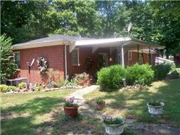 1245 Breeden Road Charlotte, TN 37036 - Photo 8 of 13 Back of the home. Landscaping and large back patio for entertaining