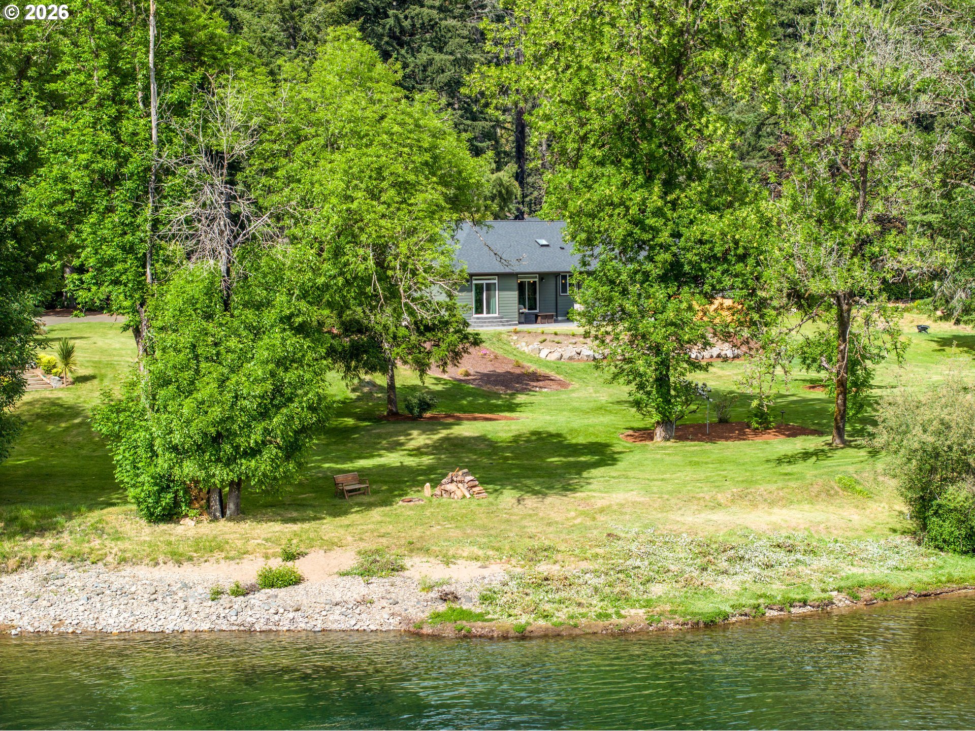 45542 South Gate Creek Road Vida, OR 97488 - Photo 1 of 46 a view of a backyard with plants and large trees