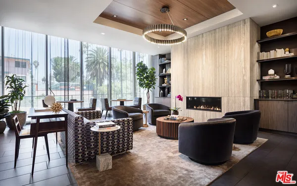 a living room with furniture a flat screen tv and a large window