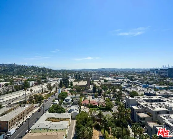 an aerial view of residential houses with city view