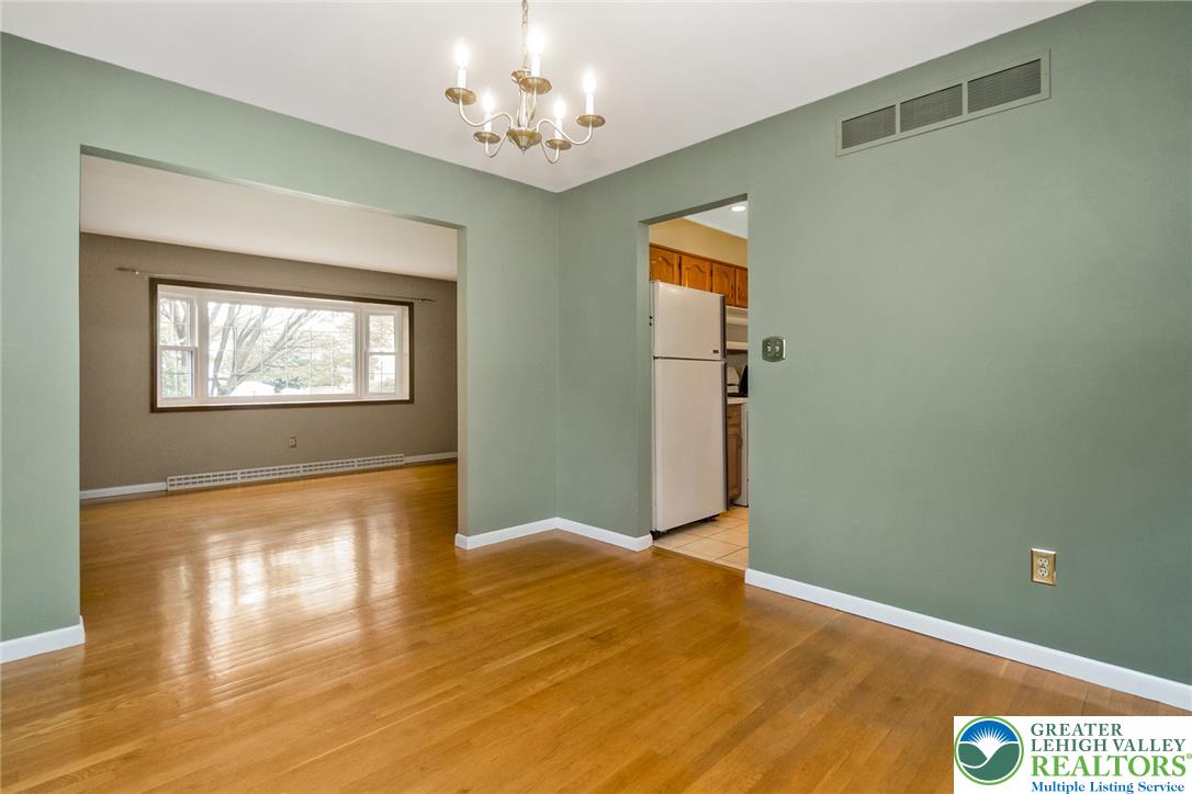 268 Apollo Drive Bethlehem, PA 18017 - Photo 11 of 56 A classic chandelier illuminates the polished wood flooring of this versatile living area, with a kitchen nearby.