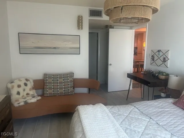 a bedroom with a bed and a chandelier