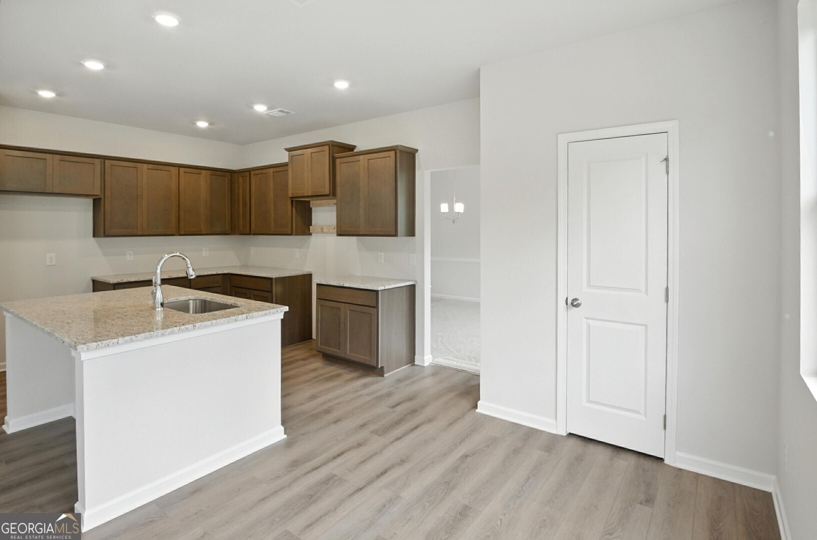 720 River Run Drive, Unit 45 Dallas, GA 30132 - Photo 11 of 53 a kitchen with a sink a stove cabinets and wooden floor