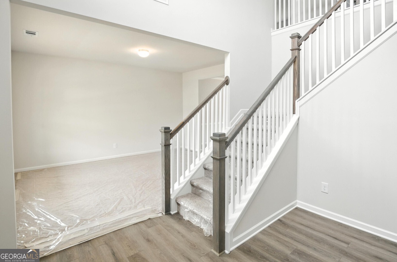 720 River Run Drive, Unit 45 Dallas, GA 30132 - Photo 4 of 53 a view of staircase with wooden floor and white walls