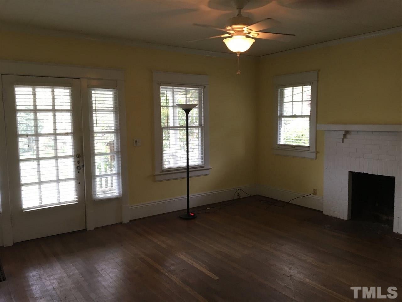 2219 The Circle Raleigh, NC 27608 - Photo 4 of 14 a view of an empty room with wooden floor and a window