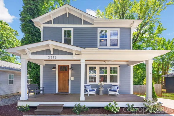 a front view of a house with garden and porch