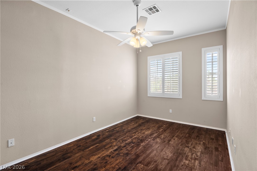 708 Vortex Avenue Henderson, NV 89002 - Photo 44 of 71 Rich hardwood-style flooring extends across this room, complemented by sun-filtering plantation shutters.