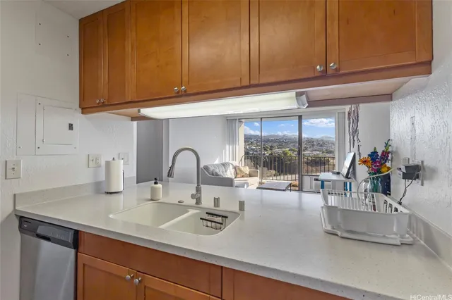 a kitchen with granite countertop a sink and cabinets