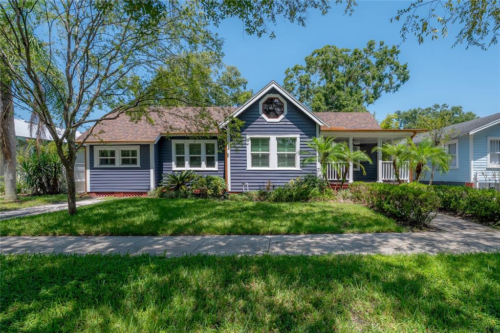 a front view of a house with a garden