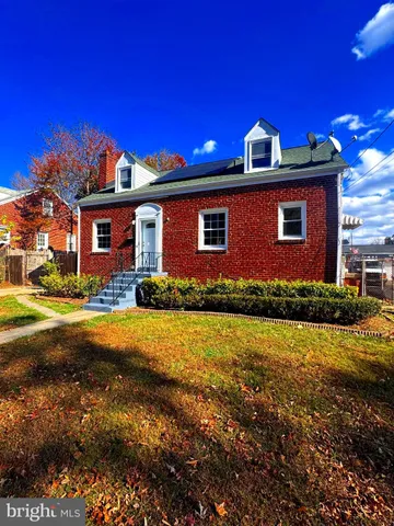 a front view of house with yard and trees
