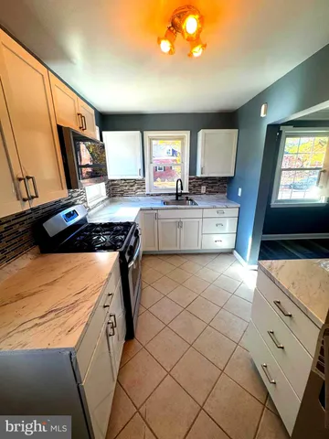 a kitchen with stainless steel appliances a stove a sink and a refrigerator