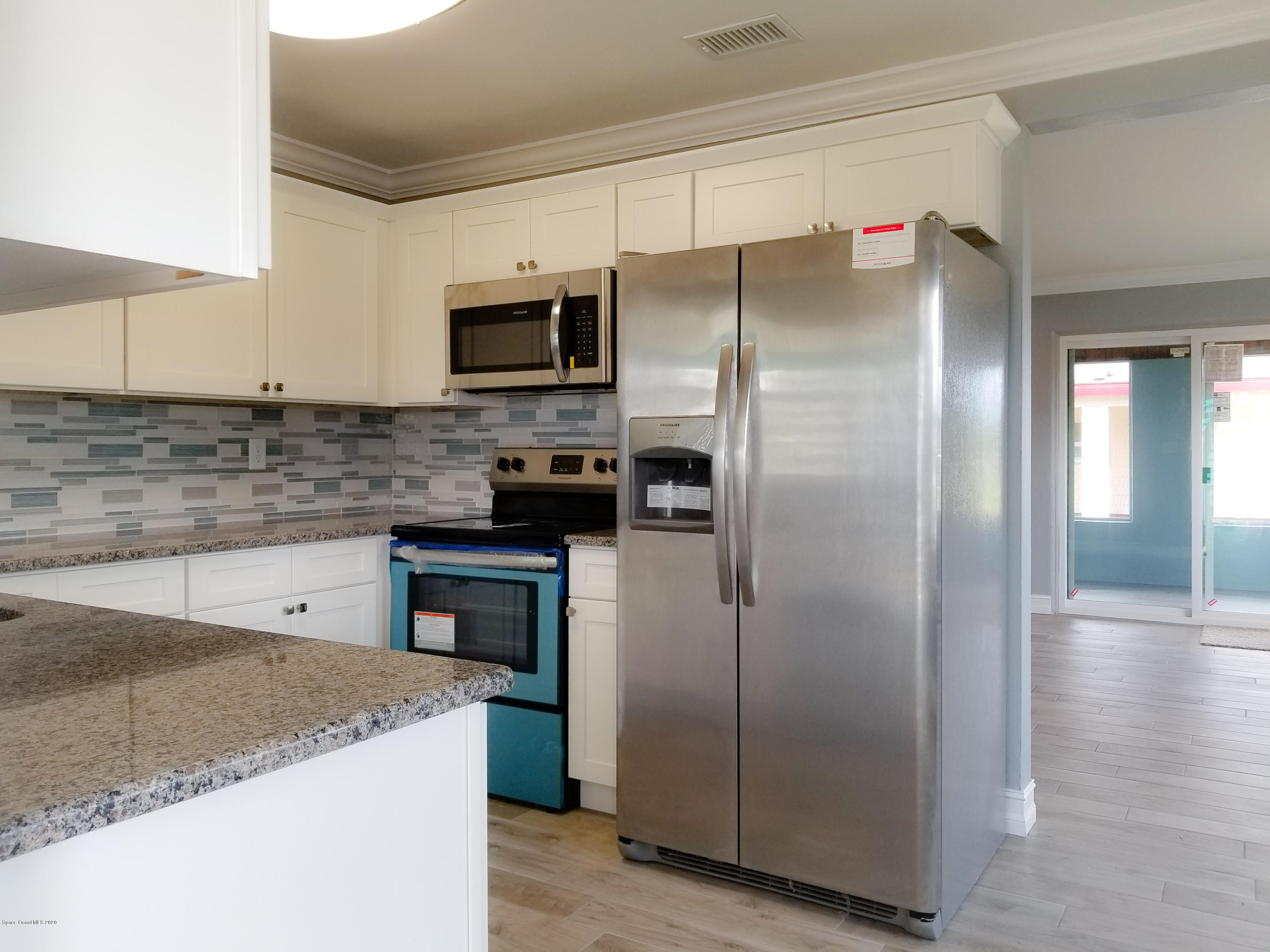 1986 Sarno Road Melbourne, FL 32935 - Photo 5 of 35 a kitchen with stainless steel appliances granite countertop a refrigerator a stove and a sink