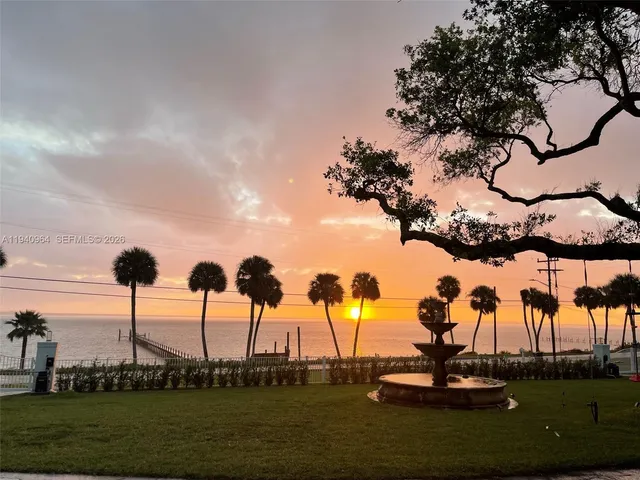 a front view of a building with a garden