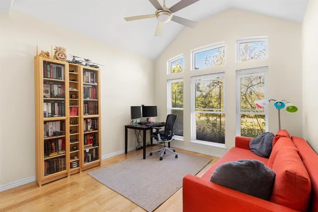 a living room with furniture and a floor to ceiling window