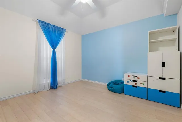 a bedroom with furniture and mirror