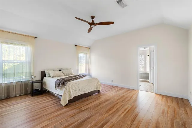 a spacious bedroom with a bed and a window