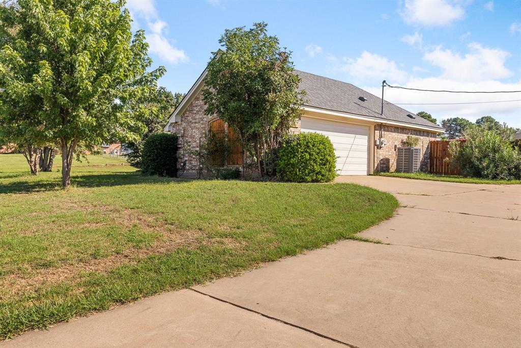 2609 Castle Road Burleson, TX 76028 - Photo 3 of 25 a front view of a house with a yard and garage