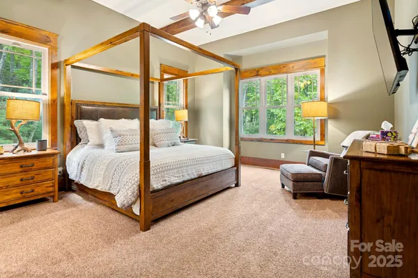 a bedroom with a bed and a couch next to a window