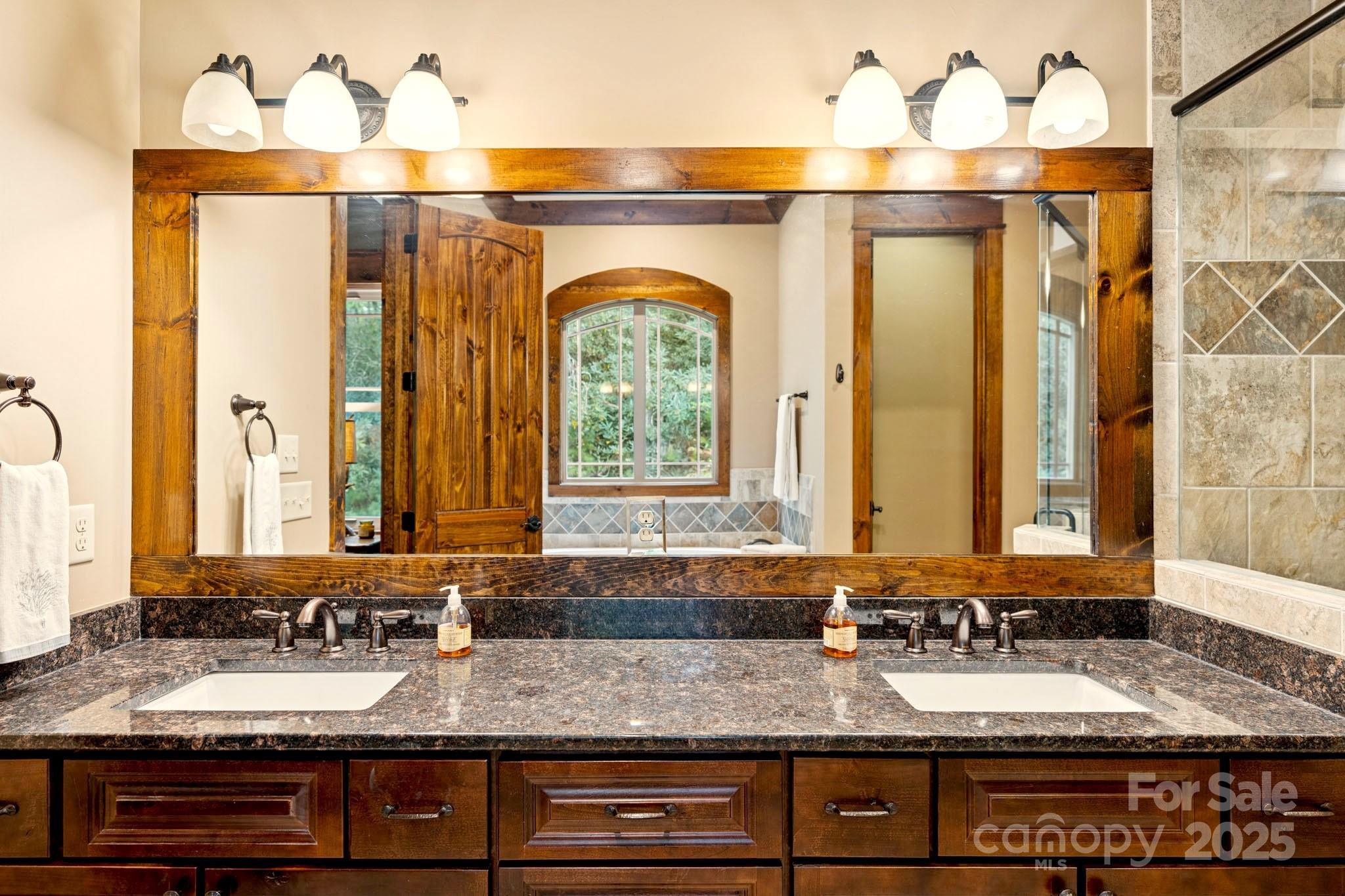 23 Dividing Ridge Trail Arden, NC 28704 - Photo 12 of 34 a bathroom with a sink and a mirror