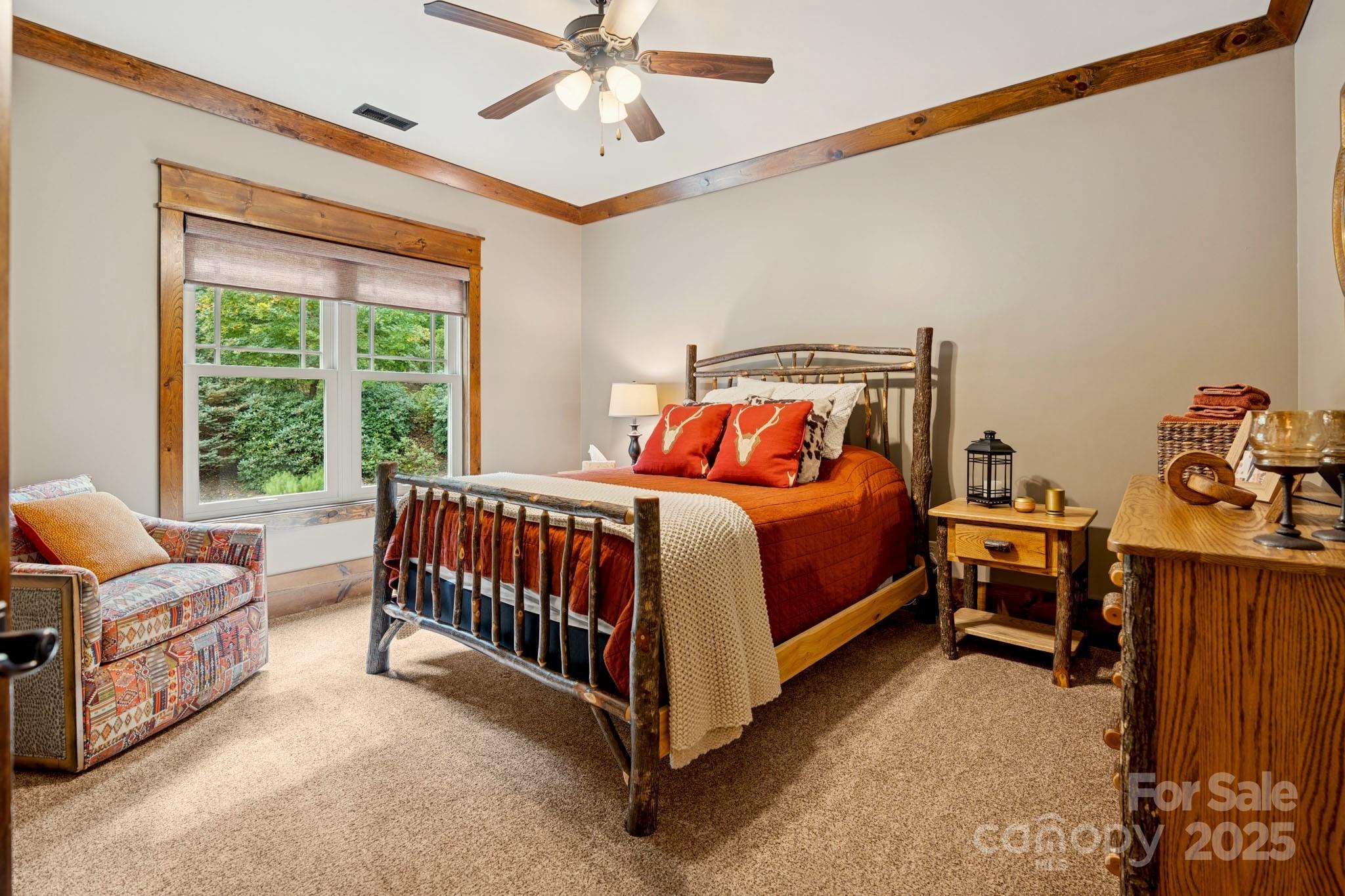 23 Dividing Ridge Trail Arden, NC 28704 - Photo 17 of 34 a bedroom with a bed and a chandelier