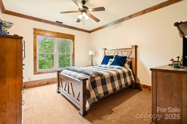 a spacious bedroom with a bed and a chandelier