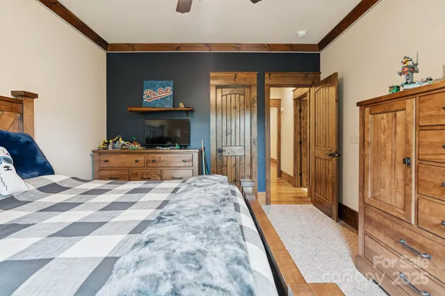 a bedroom with a bed and a large mirror with a flat tv screen