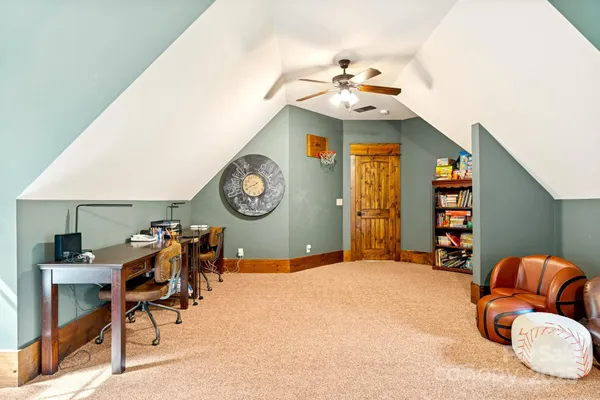 a bedroom with a bed and dresser with chair