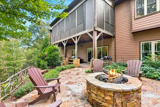 a view of house with backyard and sitting area