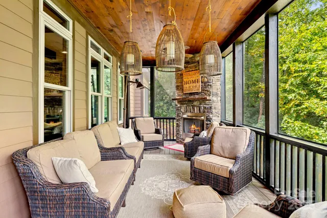 a balcony with furniture and large windows