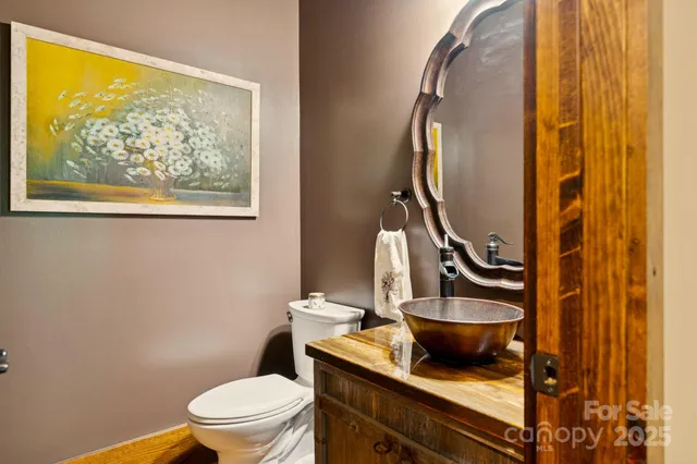 a bathroom with a toilet a sink and a mirror