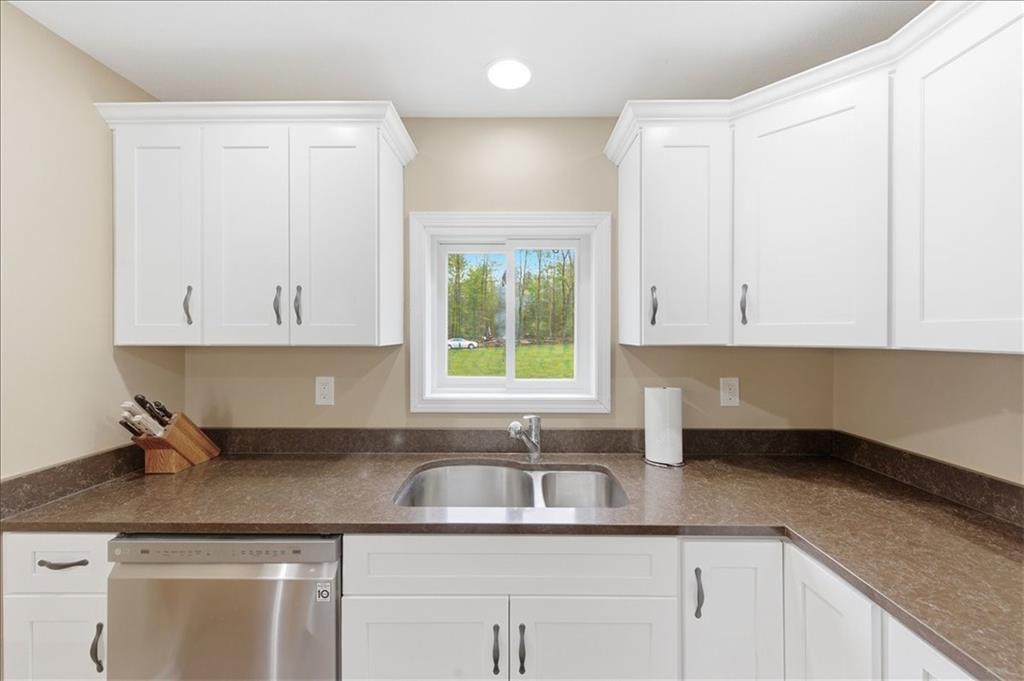 261 Hilltop Acres Road Slippery Rock, PA 16057 - Photo 15 of 35 a kitchen with granite countertop a sink white cabinets and a window