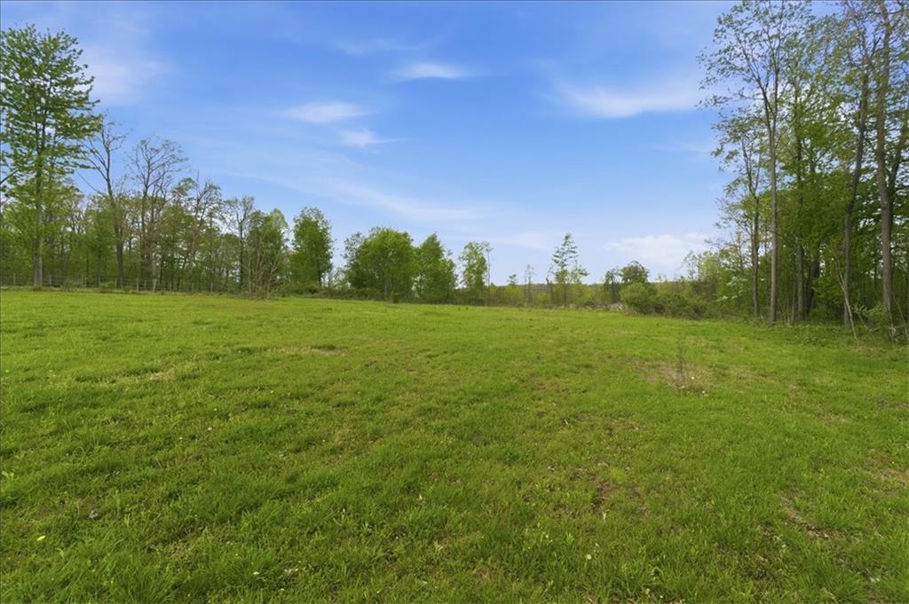 261 Hilltop Acres Road Slippery Rock, PA 16057 - Photo 34 of 35 a view of a green field with trees in the background