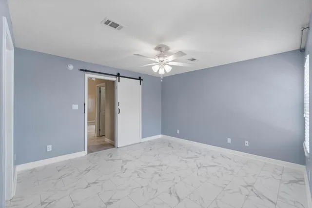 a view of a livingroom with a ceiling fan and a chandelier fan