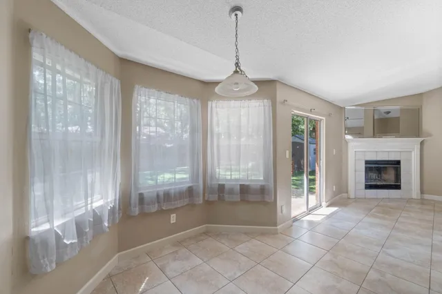 a view of a livingroom with a chandelier and fireplace