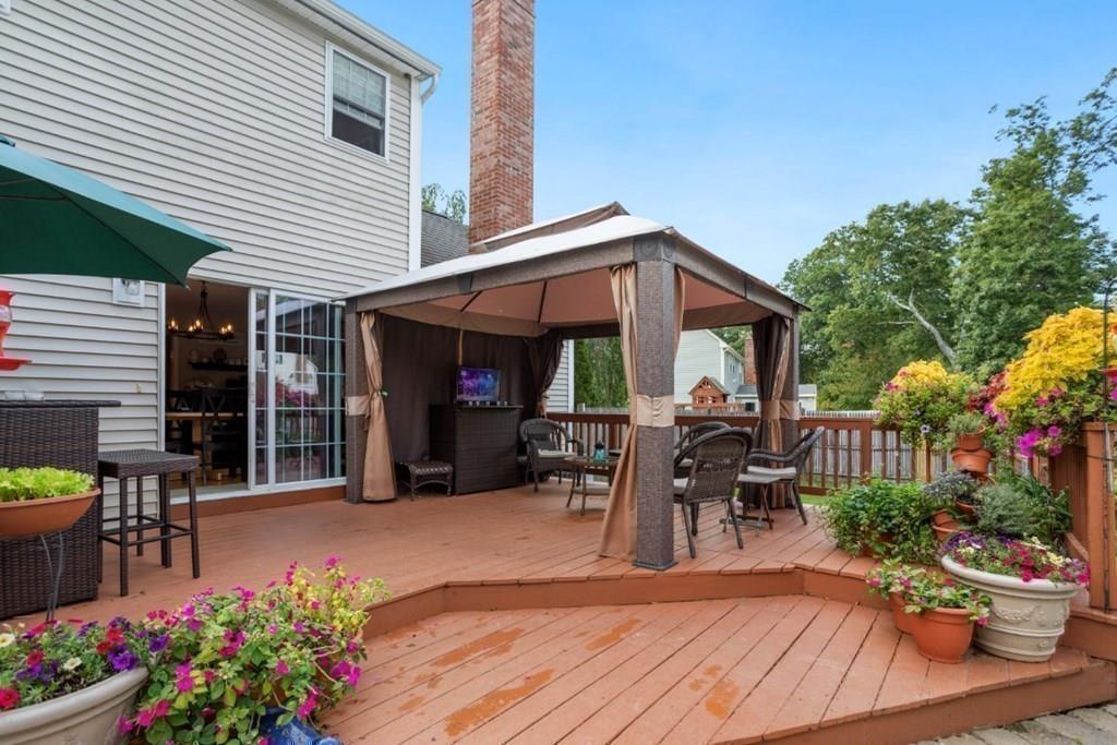 90 Fairview Park Road Sturbridge, MA 01566 - Photo 33 of 42 a view of a patio with table and chairs potted plants and a house
