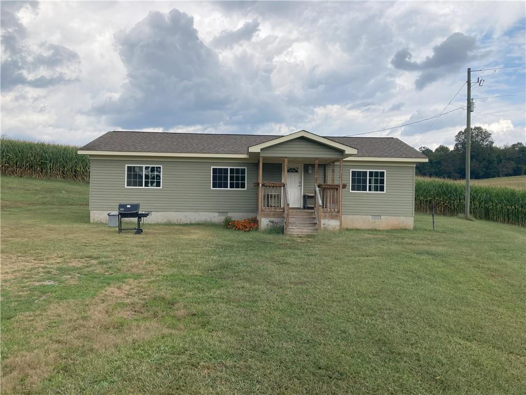 a front view of house with yard and green space