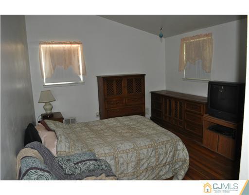 16 Donald Road East Brunswick, NJ 08816 - Photo 15 of 25 a bedroom with a bed and a window